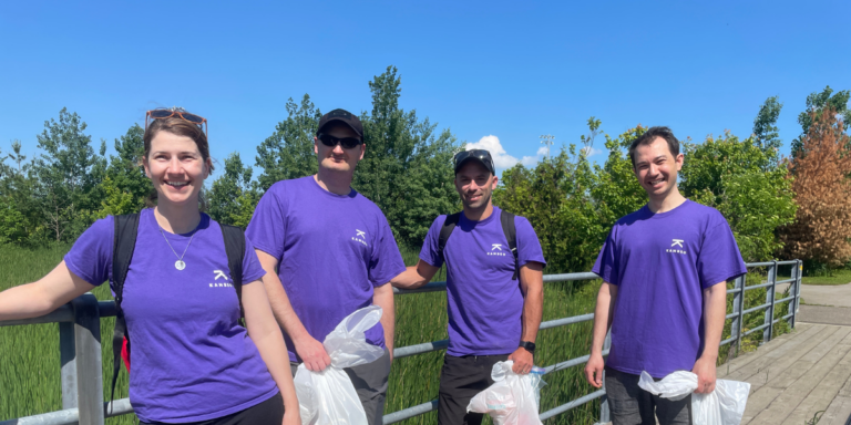 Four employees smiling after completing a volunteer day
