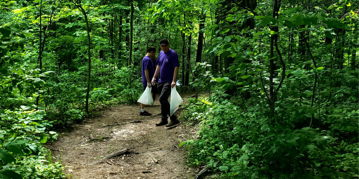 Two Kambeo employees picking up trash along the Bruce Trail